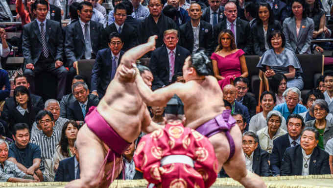 US President Donald Trump and First Lady Melania Trump are accompanied by Japan's Prime Minister Shinzo Abe and his wife Akie Abe (centre row) as they watch a sumo battle during the Summer Grand Sumo Tournament in Tokyo on May 26, 2019. (Photo by Brendan SMIALOWSKI / AFP) (Photo credit should read BRENDAN SMIALOWSKI/AFP/Getty Images)