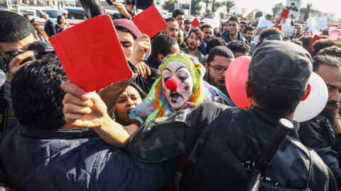 TUNIS, TUNISIA - JANUARY 26: A demonstrator, wearing a clown costume, from Tunisia's 'Fech Nestannew' (What are we waiting for?) youth movement attends a protest against high cost of living after the new budget law outside the Parliament building in Tunis, Tunisia on January 26, 2018. (Photo by Yassine Gaidi/Anadolu Agency/Getty Images)