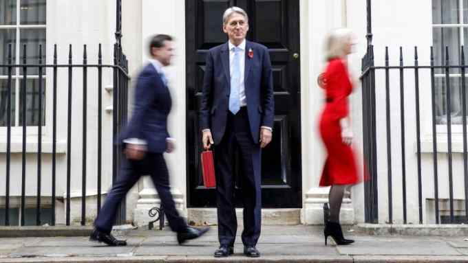 Chancellor of the Exchequer Philip Hammond poses outside No 11, Downing Street before presenting the government's new budget plan to the Parliament on October 29, 2018.