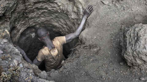 KAWAMA, DEMOCRATIC REPUBLIC OF CONGO - JUNE 8: A creuseur, or digger, descends into a copper and cobalt mine in Kawama, Democratic Republic of Congo on June 8, 2016. Cobalt is used in the batteries for electric cars and mobile phones. Working conditions are dangerous, often with no safety equipment or structural support for the tunnels. The diggers say they are paid on average US$2-3/day. (Photo by Michael Robinson Chavez/The Washington Post via Getty Images)