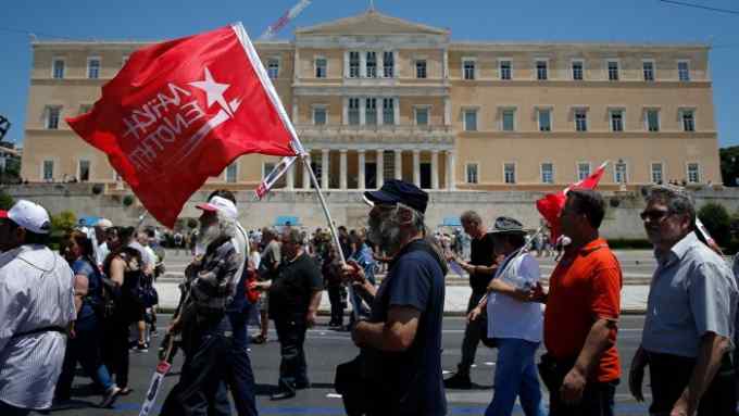 Protesters march outside the Greek parliament building during a protest against austerity in Athens, Greece, June 14, 2018. REUTERS/Costas Baltas