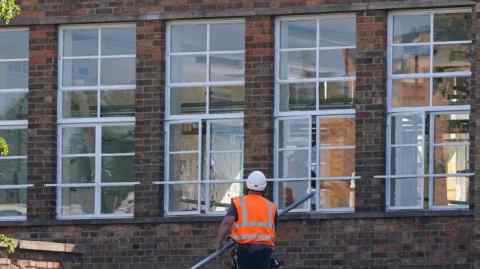 A worker carries out repairs to a school in Leicester. The National Audit Office warned in June that 700,000 pupils were at schools needing major rebuilding or refurbishment