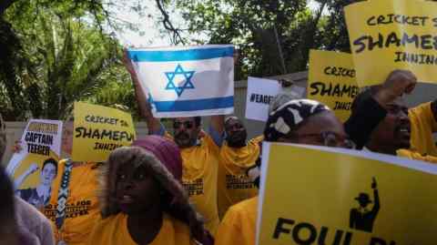 Protesters holding signs and an Israeli flag outside Cricket South Africa in Johannesburg, South Africa on January 18 2024