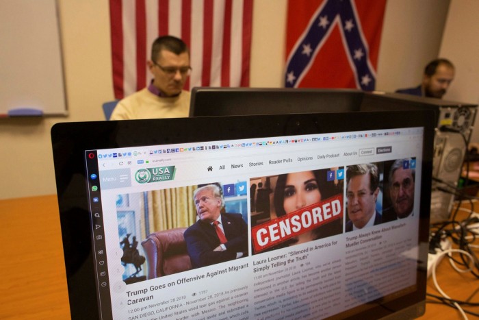 A page featuring editorial from the USAReally.com website sits on a desktop computer monitor. A man and a Confederacy flag are in the background